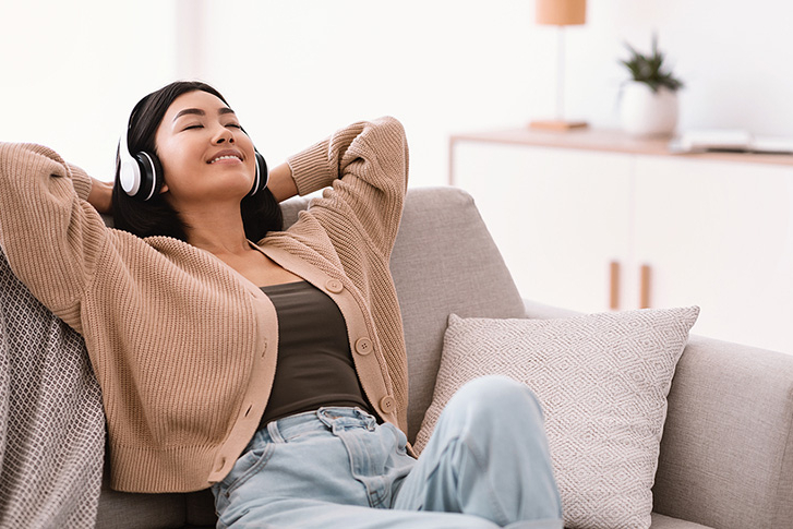 Relaxed Woman Listening to Music with Headphones.