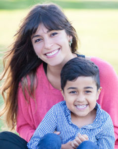 Mother and son smiling outside