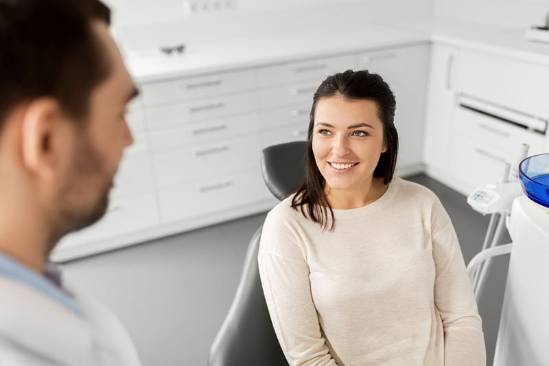 Woman talking to dentist